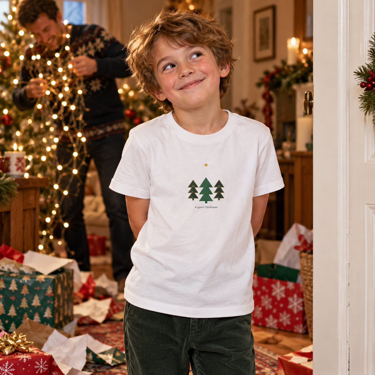 Illustrative lifestyle scene of a child wearing the white geometric Christmas tree T-shirt